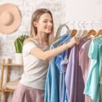 A woman looking through clothing items on a rack.